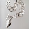 hammered silver bracelet with forged leaf charm