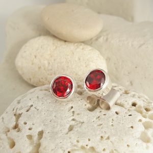 Small stud earrings handmade with silver and Swarovski red zirconias.