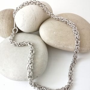 Silver chain necklace woven in the byzantine pattern style. classic and timeless jewelry you ma y wear all year long